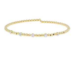 Yellow gold flexible ball bracelet with five diamond elements