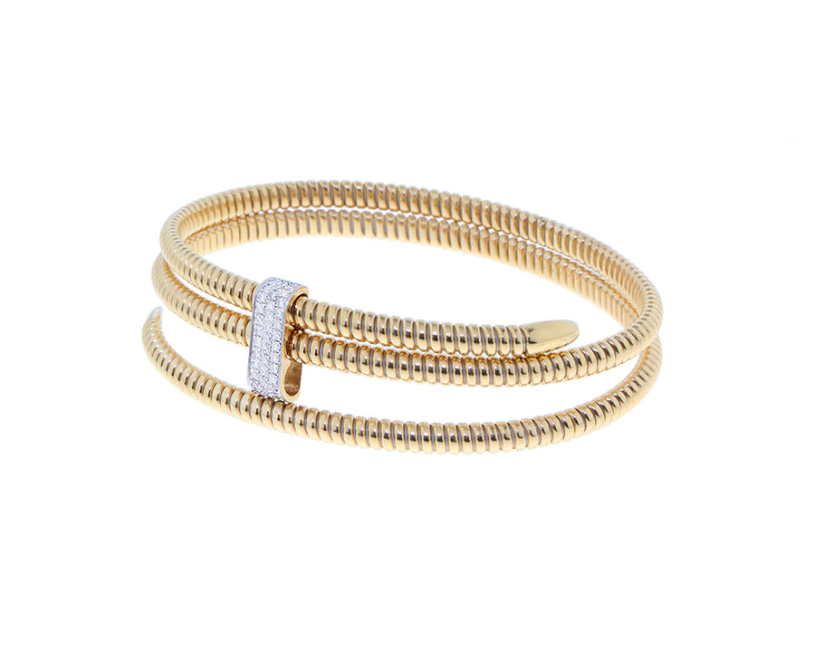Yellow gold triple tubo bracelet with a diamond element