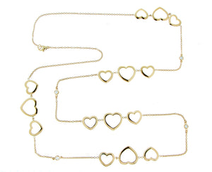 Yellow gold long necklace with open heart charms and diamonds