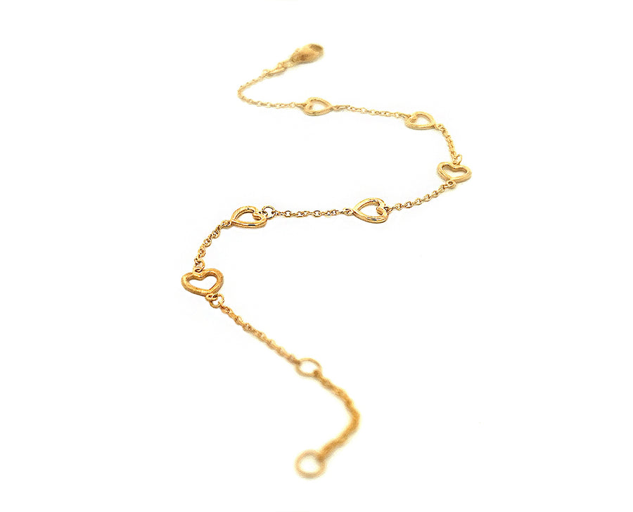Yellow gold bracelet with tiny open hearts