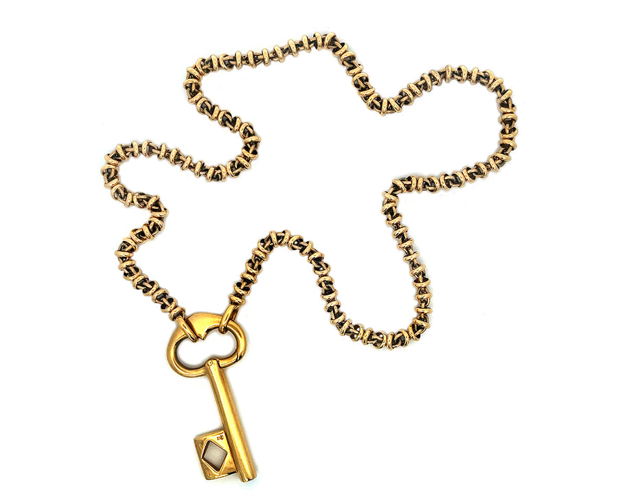 Yellow gold Pomellato necklace with key pendant