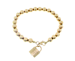 Yellow gold ball bracelet with a lock charm