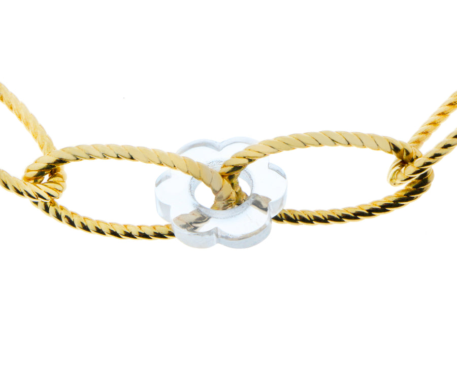 Yellow gold twisted chain bracelet with a flower charm