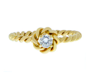 Yellow gold twisted ring with a diamond