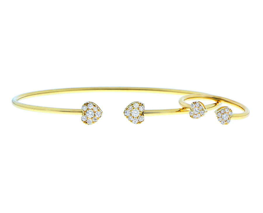 Yellow gold bangle with two diamond hearts