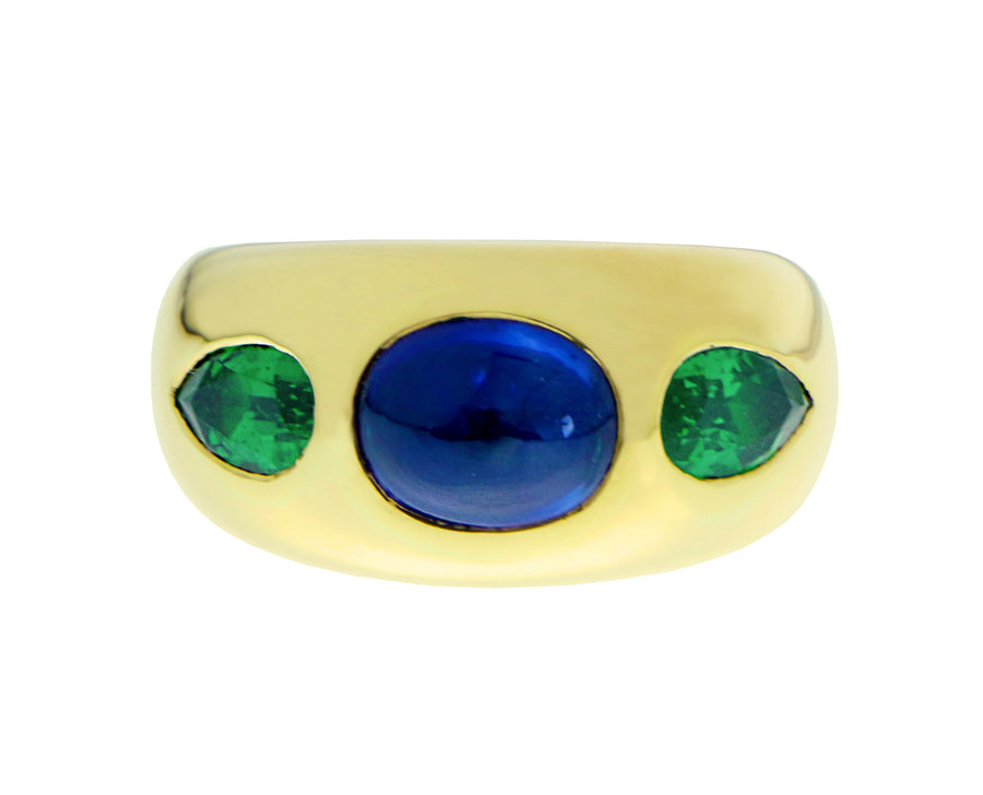 Yellow gold gypsy ring with a cabochon cut sapphire and tsavorites