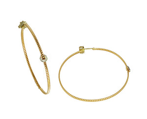 Yellow gold tubo hoops with a diamond piece
