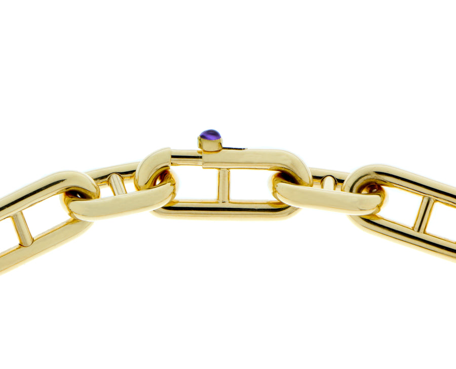 Yellow gold chain bracelet with a small cabochon cut sapphire