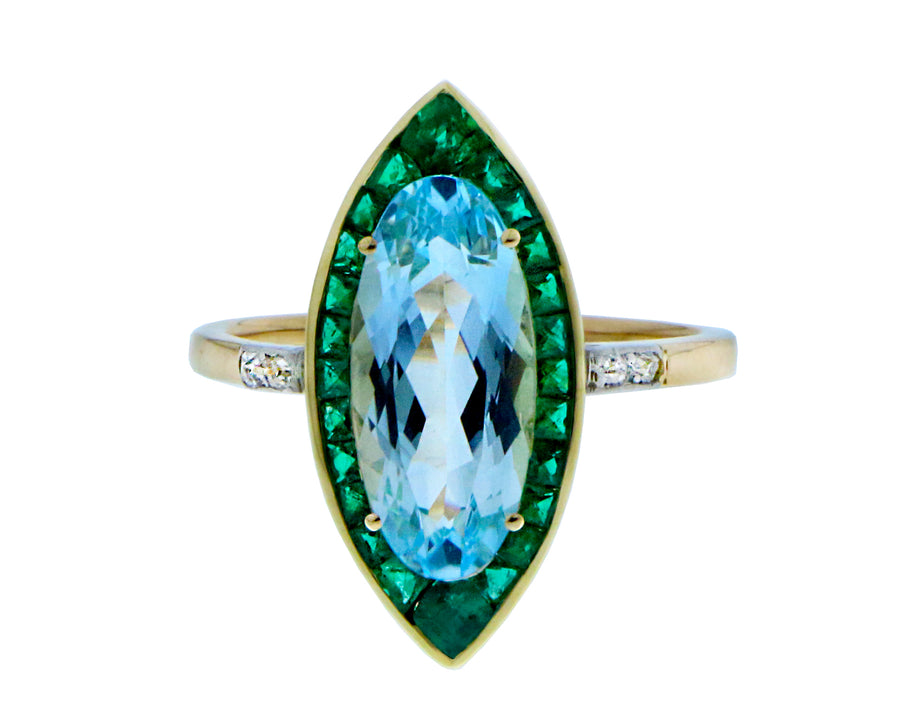 Geelgouden ring met een blauwe topaas, smaragden en diamanten